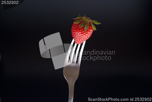 Image of fresh strawberry on fork 