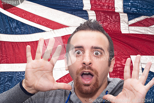 Image of young amazed man portrait with british flag