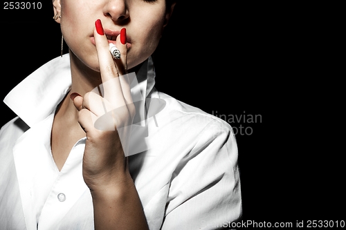 Image of Young woman smoking in the studio