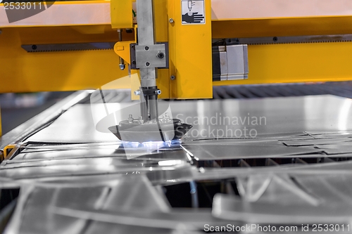 Image of Machine cutting steel in a factory