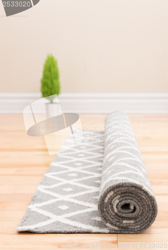 Image of Unrolling carpet in a new home