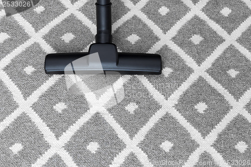 Image of Vacuum cleaner on gray carpet