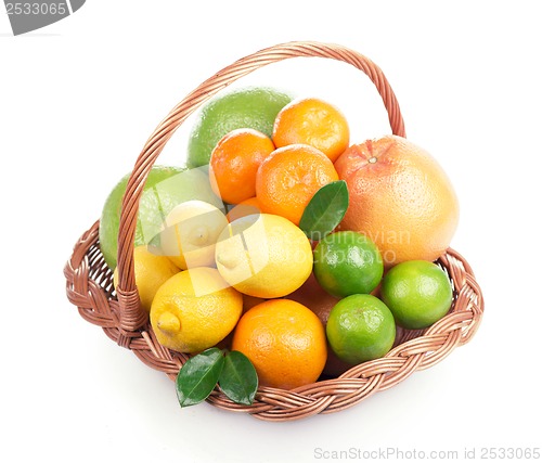 Image of Fresh citrus fruit with leaves in a wicker basket