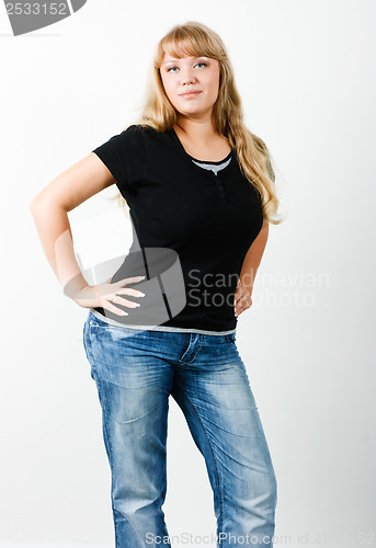 Image of Young woman in jeans with long hair