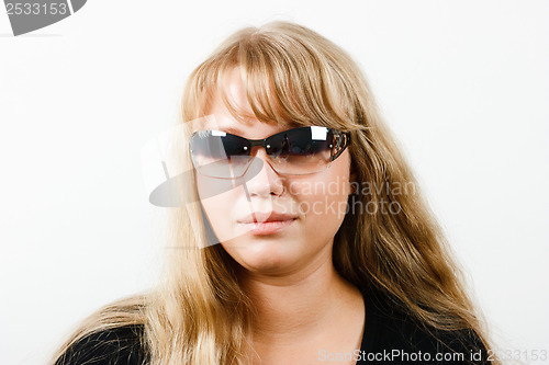 Image of Young woman in sunglasses