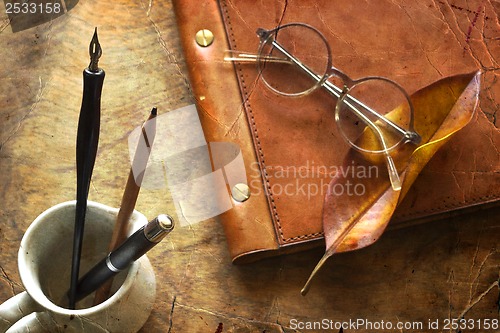 Image of Busines concept with retro glasses, notebook, ink pen on wooden background