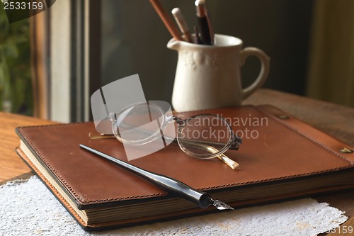 Image of Busines concept with retro glasses, notebook, ink pen on wooden background
