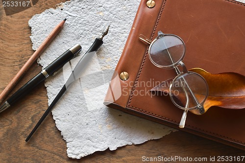 Image of Busines concept with retro glasses, notebook, ink pen on wooden background
