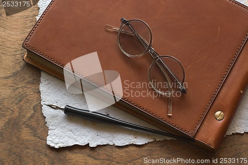 Image of Busines concept with retro glasses, notebook, ink pen on wooden background