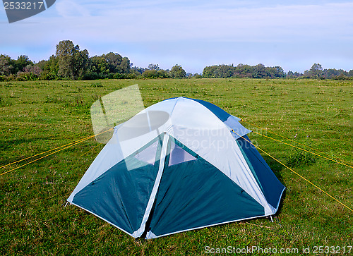 Image of Private camping tent on the meadow near the river.