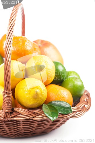 Image of Fresh citrus fruit with leaves in a wicker basket