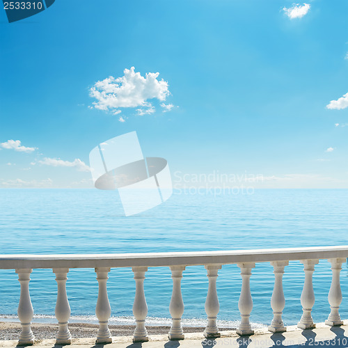 Image of white balcony over sea and blue sky