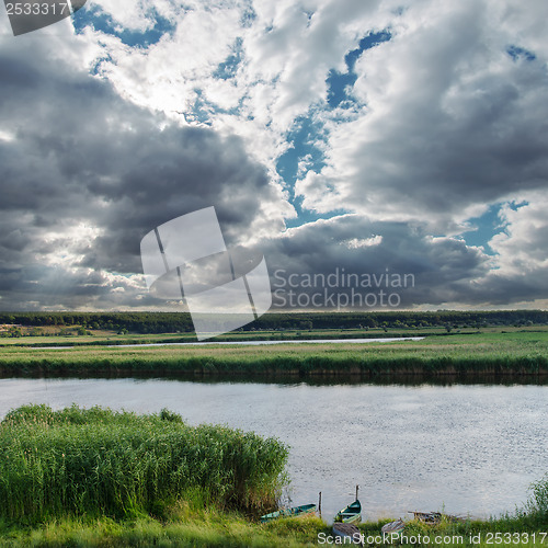 Image of low darken clouds over river