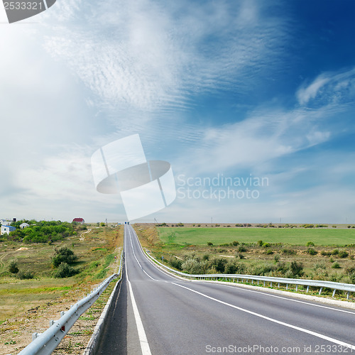 Image of cloudy sky over asphalt road