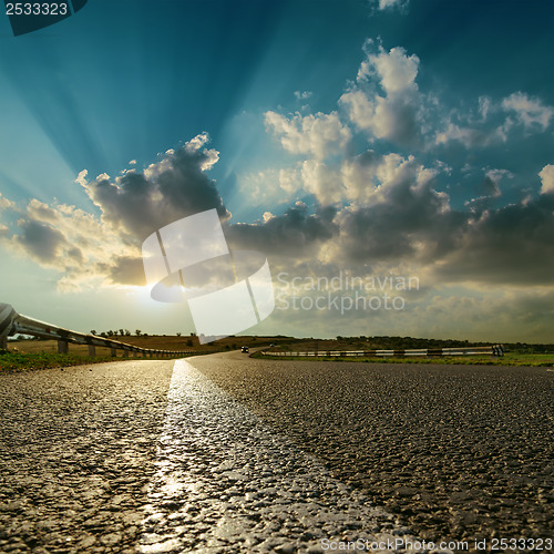 Image of asphalt road close up to sunset