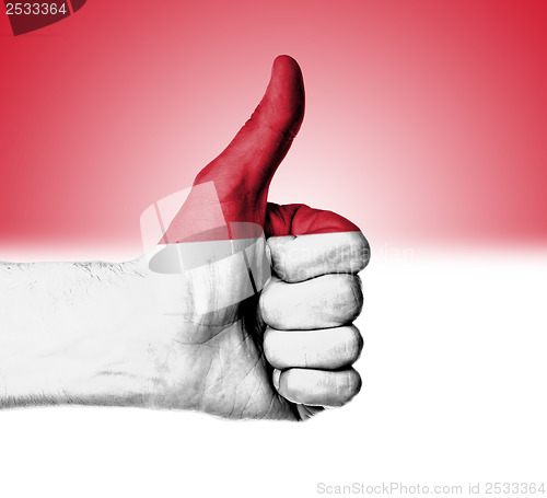 Image of Closeup of male hand showing thumbs up sign