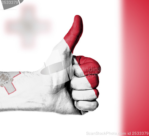 Image of Closeup of male hand showing thumbs up sign