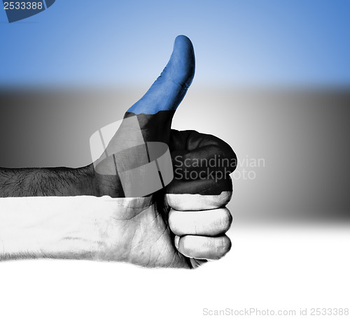 Image of Closeup of male hand showing thumbs up sign