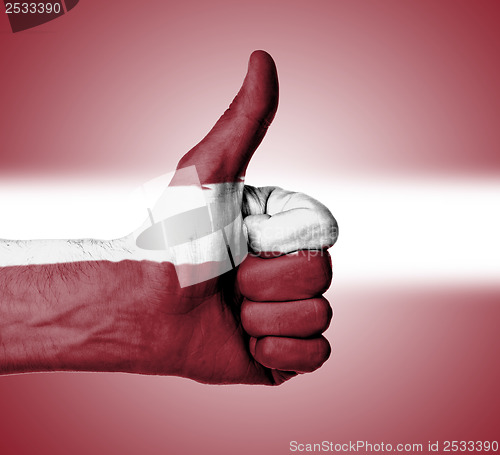 Image of Closeup of male hand showing thumbs up sign