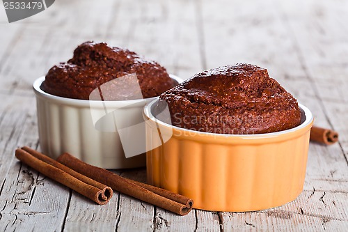 Image of two fresh baked browny cakes and cinnamon sticks