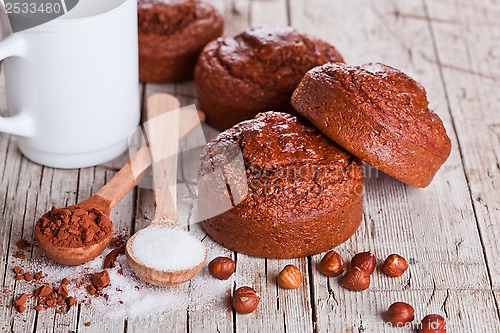 Image of fresh baked browny cakes, milk, sugar, hazelnuts and cacao 