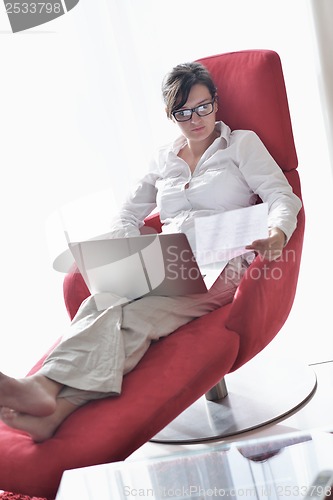 Image of woman using a laptop computer at home