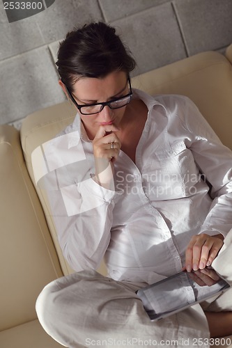 Image of woman using tablet pc at home