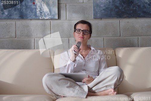 Image of woman using tablet pc at home