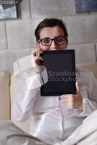 Image of woman using tablet pc at home