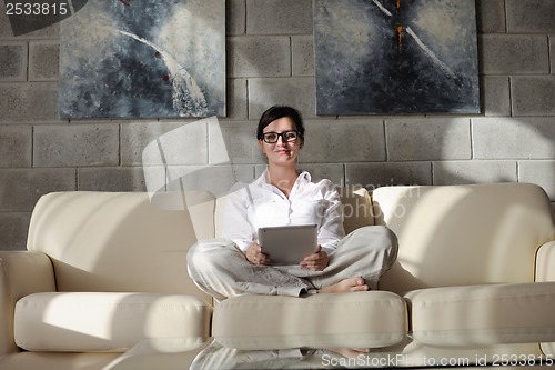 Image of woman using tablet pc at home