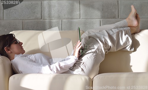Image of woman using tablet pc at home