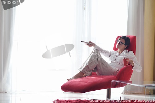 Image of happy young woman relax at home on sofa