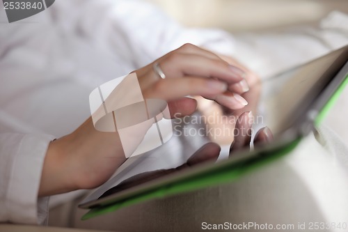 Image of woman using tablet pc at home