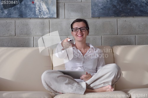 Image of happy young woman relax at home on sofa