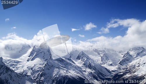 Image of Panorama of snowy mountains in clouds