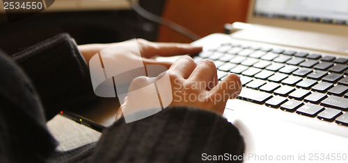 Image of Young woman working on laptop