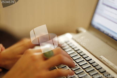 Image of Young woman working on laptop