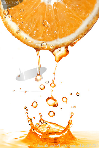 Image of orange slice and splash of juice isolated on white