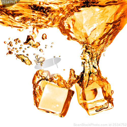 Image of ice cubes dropped into orange water with splash isolated on whit