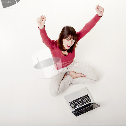 Image of Happy woman with a laptop