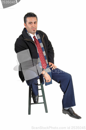 Image of Man sitting in coat.