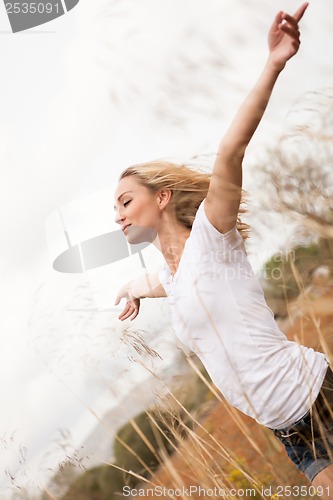 Image of young happy attractive woman arms wide open 
