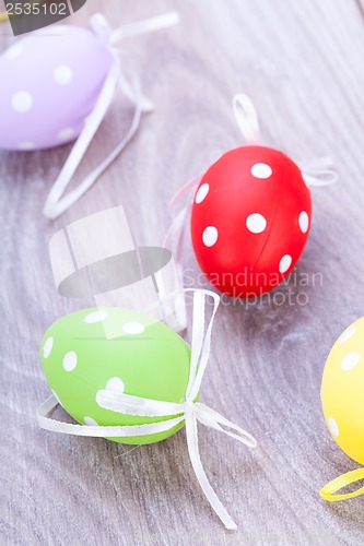 Image of colorful easter egg decoration on wooden background