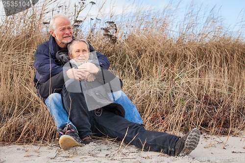 Image of happy mature couple relaxing baltic sea dunes 