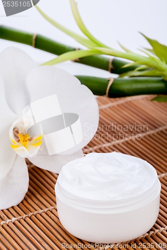 Image of cosmetic face cream on wooden background 