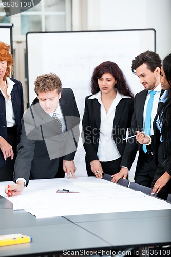 Image of business people discussing architecture plan sketch 