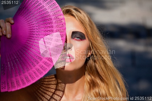 Image of young beautiful woman with smokey eyes and pink lips