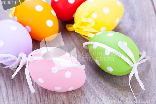 Image of colorful easter egg decoration on wooden background