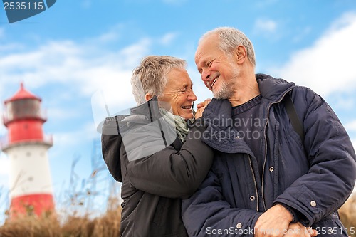 Image of happy mature couple relaxing baltic sea dunes 