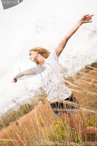 Image of young happy attractive woman arms wide open 